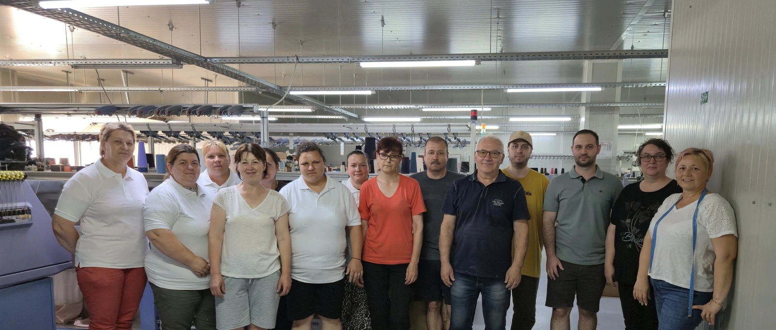 The Moga Knitworks production team beside the STOLL machines in Darabani